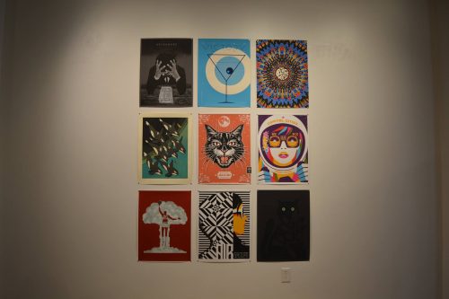 Collection of nine colorful vintage-style posters displayed in a 3x3 grid on white wall featuring various artistic designs