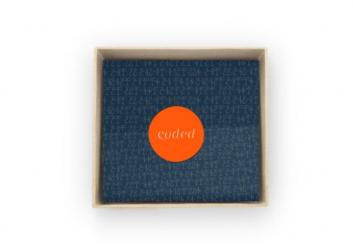 Wooden box with blue background covered in coded numbers and orange circle with coded text in center