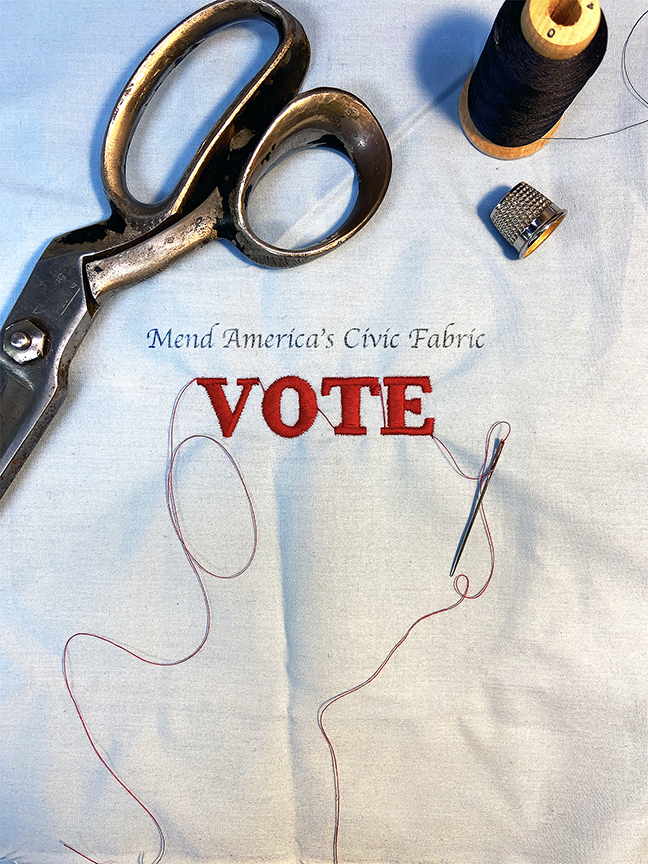 Vintage scissors, thread spool, thimble and needle on white fabric with VOTE text and Mend America's Civic Fabric message