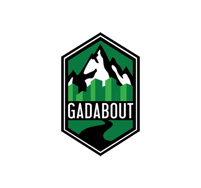 1 gadabout-logo Gadabout logo featuring green hexagonal badge with snow-capped mountains, city skyline, and winding road design