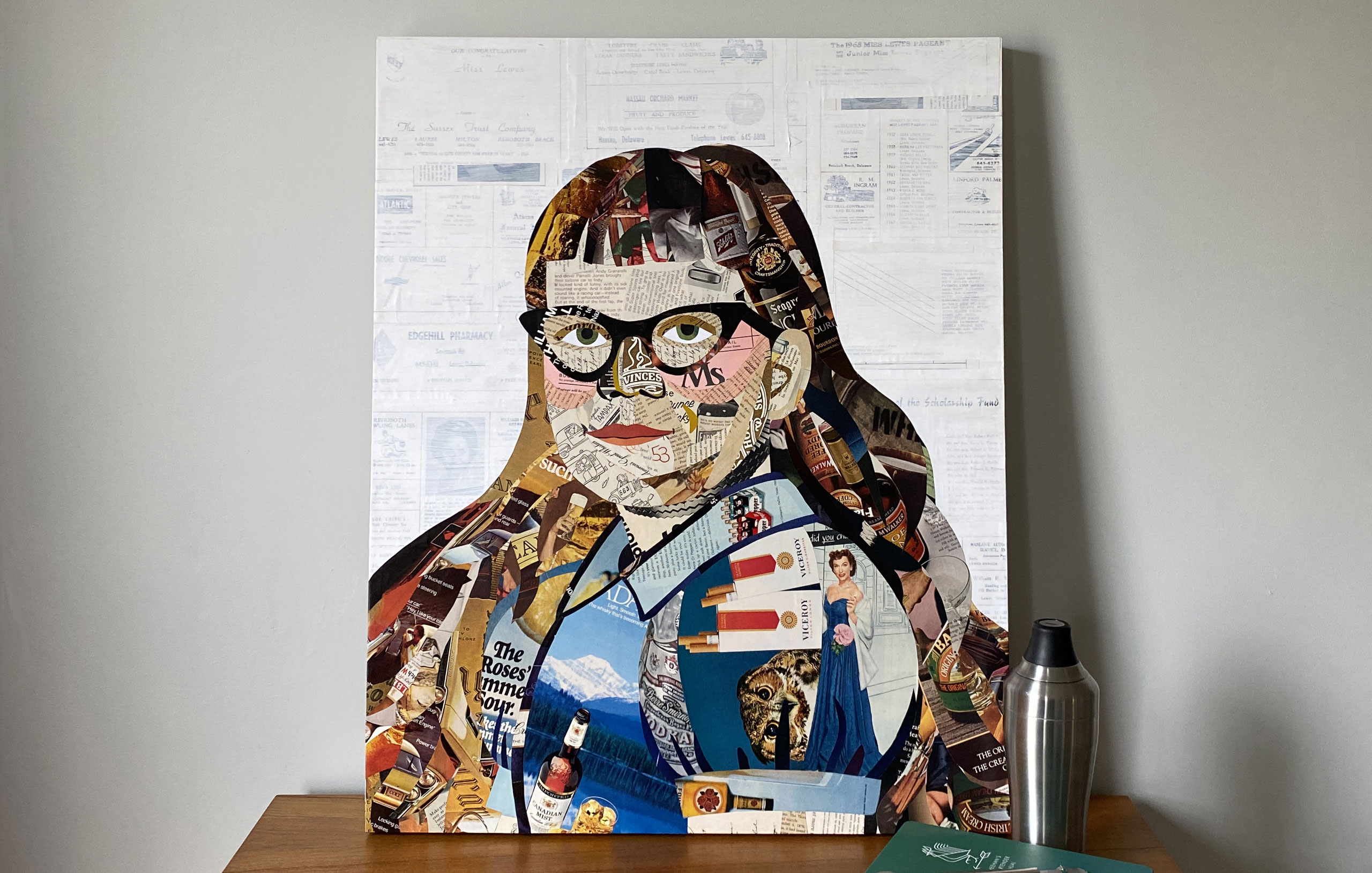Colorful collage artwork portrait of woman with glasses made from magazine clippings and newspaper cutouts on canvas