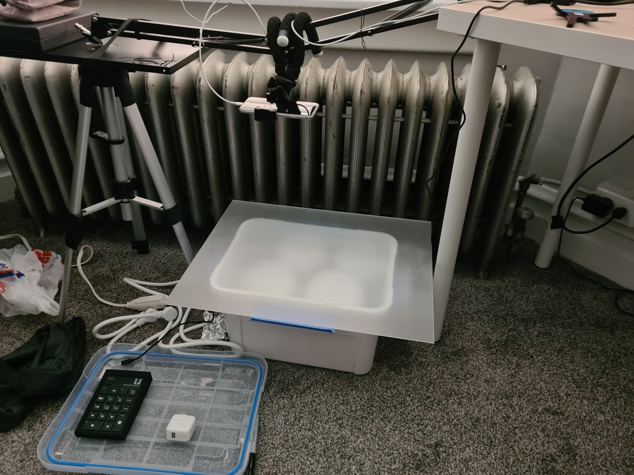 001-LightBoxSetup White 3D printer setup on desk with radiator, cables, and calculator on tray in workspace environment