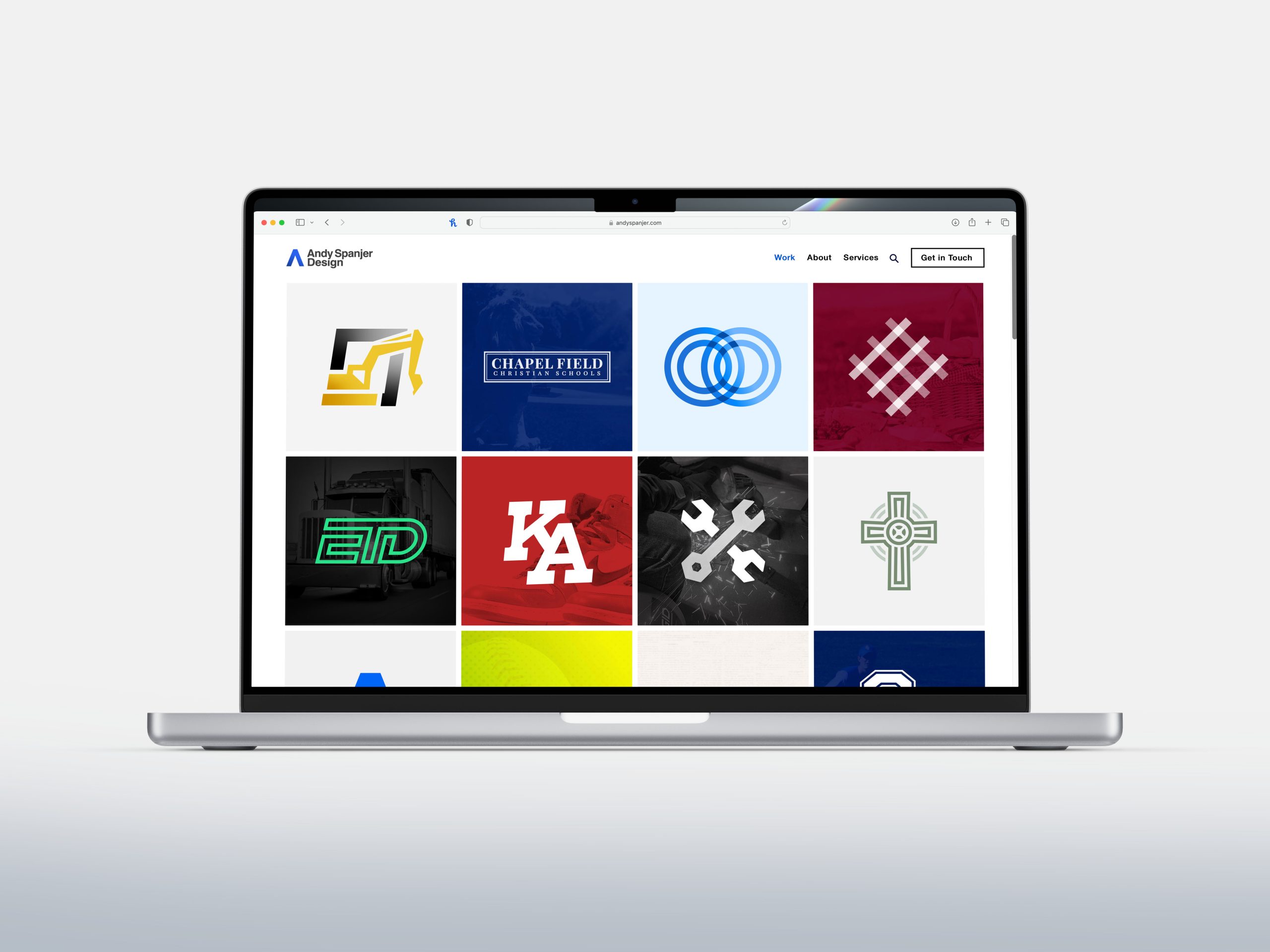 03 Andy Spanjer Design portfolio website displayed on MacBook showing colorful logo designs in grid layout