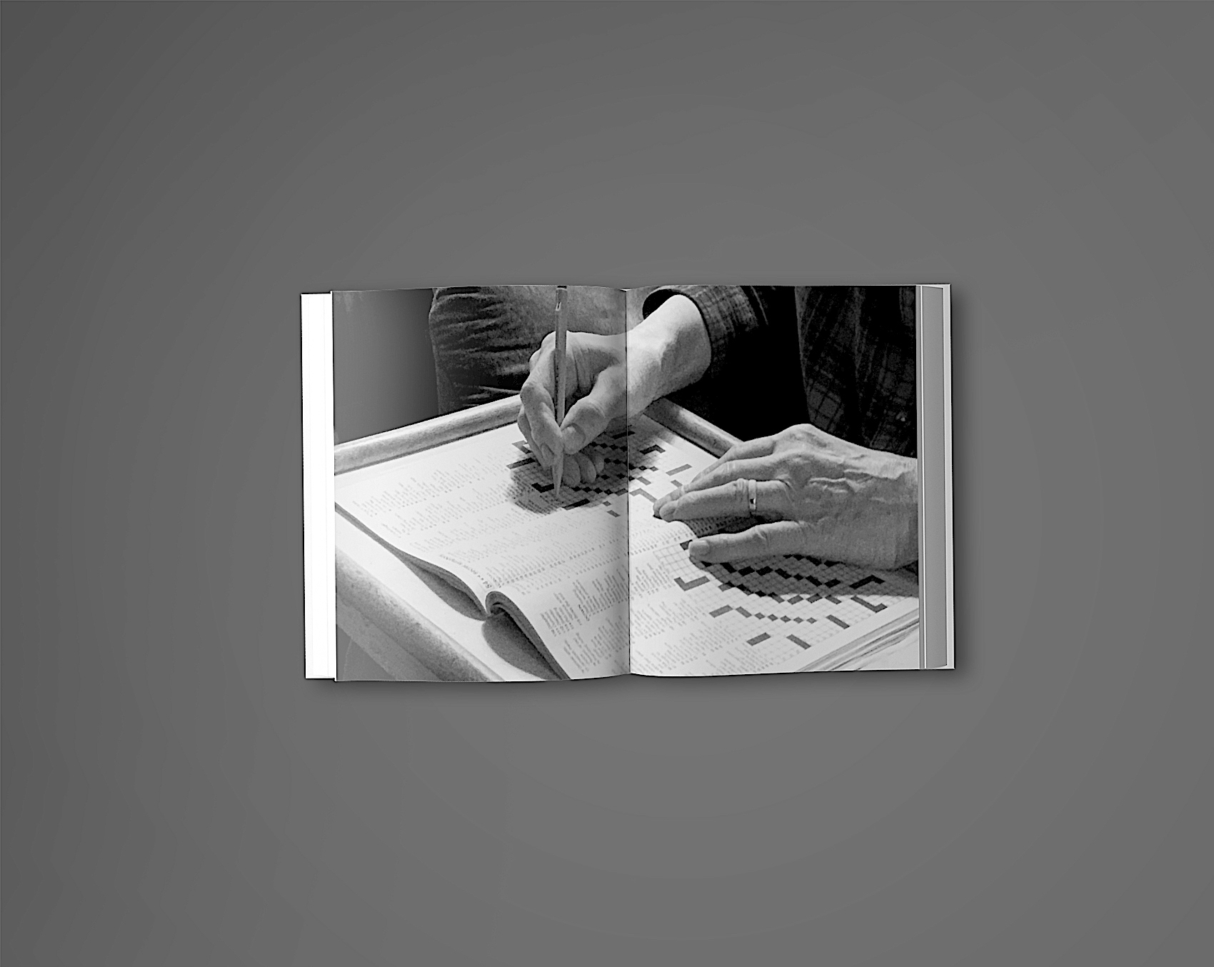 04 Hands working with small paper pieces on open book pages, black and white photography showing detailed craftsmanship