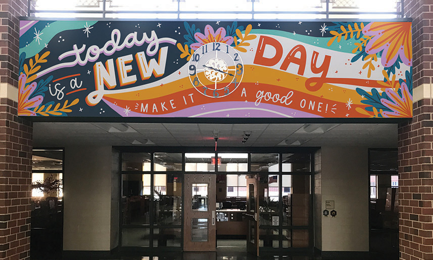 1_Mural Colorful mural above school entrance reads Today is a NEW DAY - Make it a good one! with clock and decorative elements