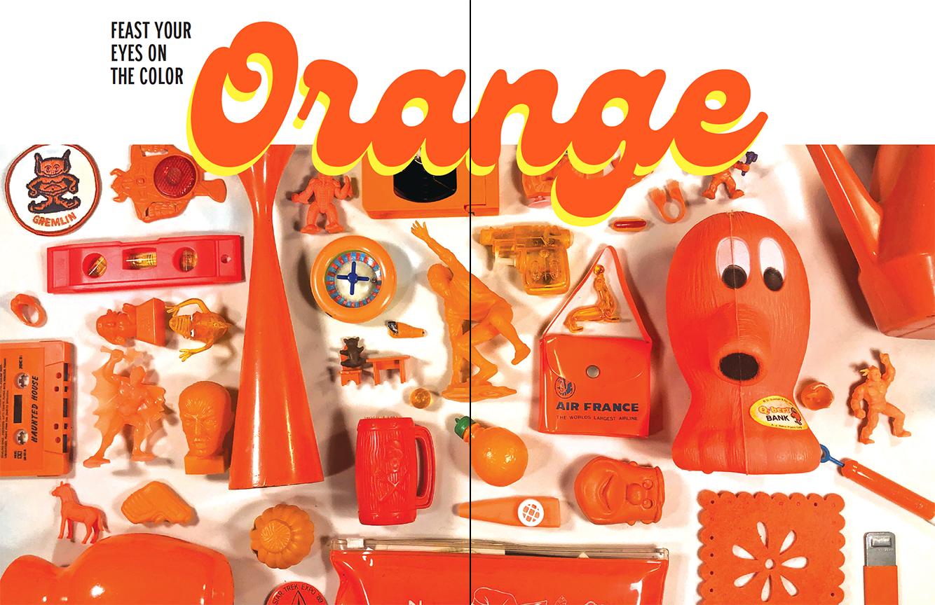 Demaraiszine6 Collection of vintage orange toys and objects including compass, level, Air France bag, and various playthings displayed