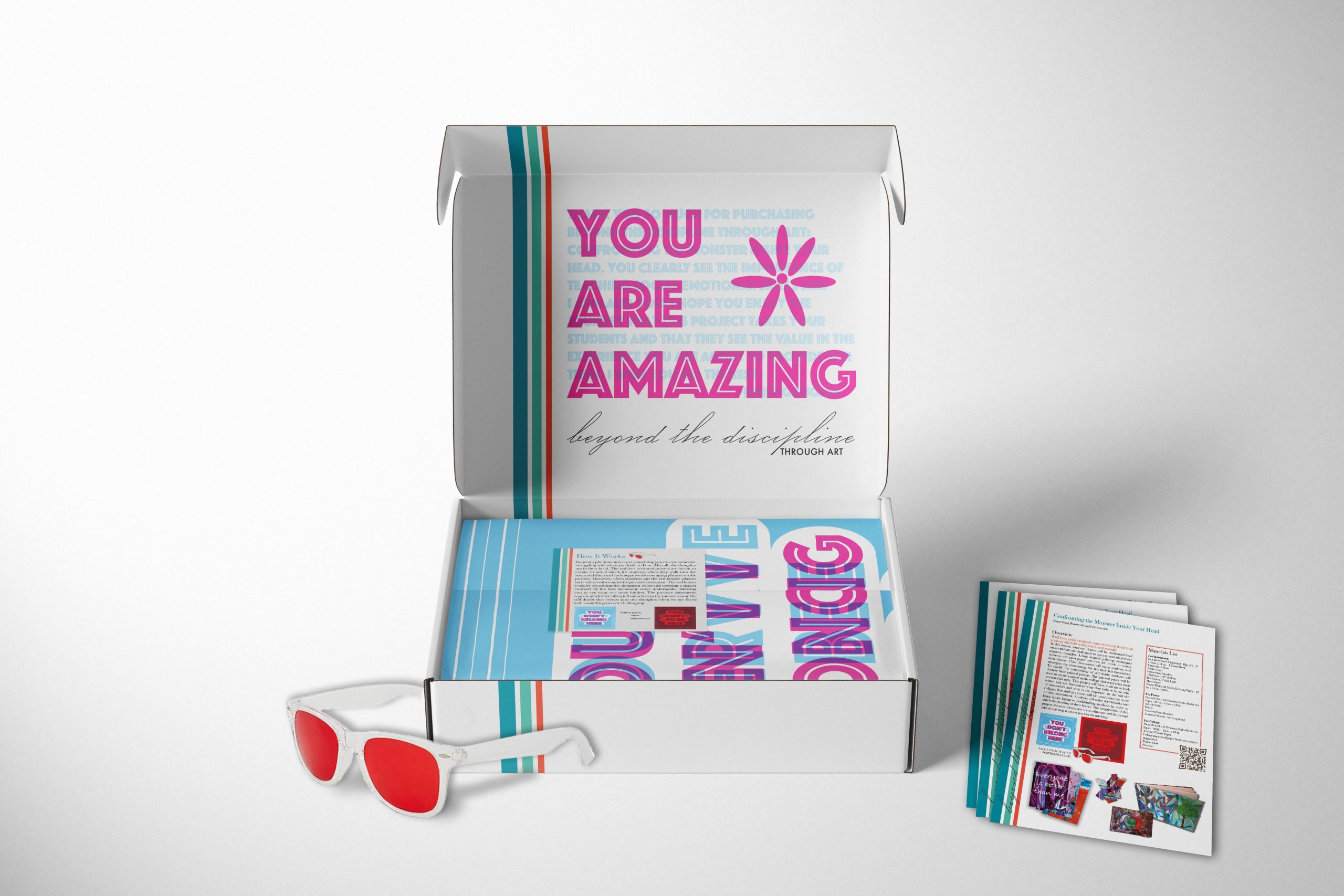 Gaugler_mailing box for imposter project You Are Amazing art therapy subscription box with 3D glasses, colorful materials, and inspirational worksheets
