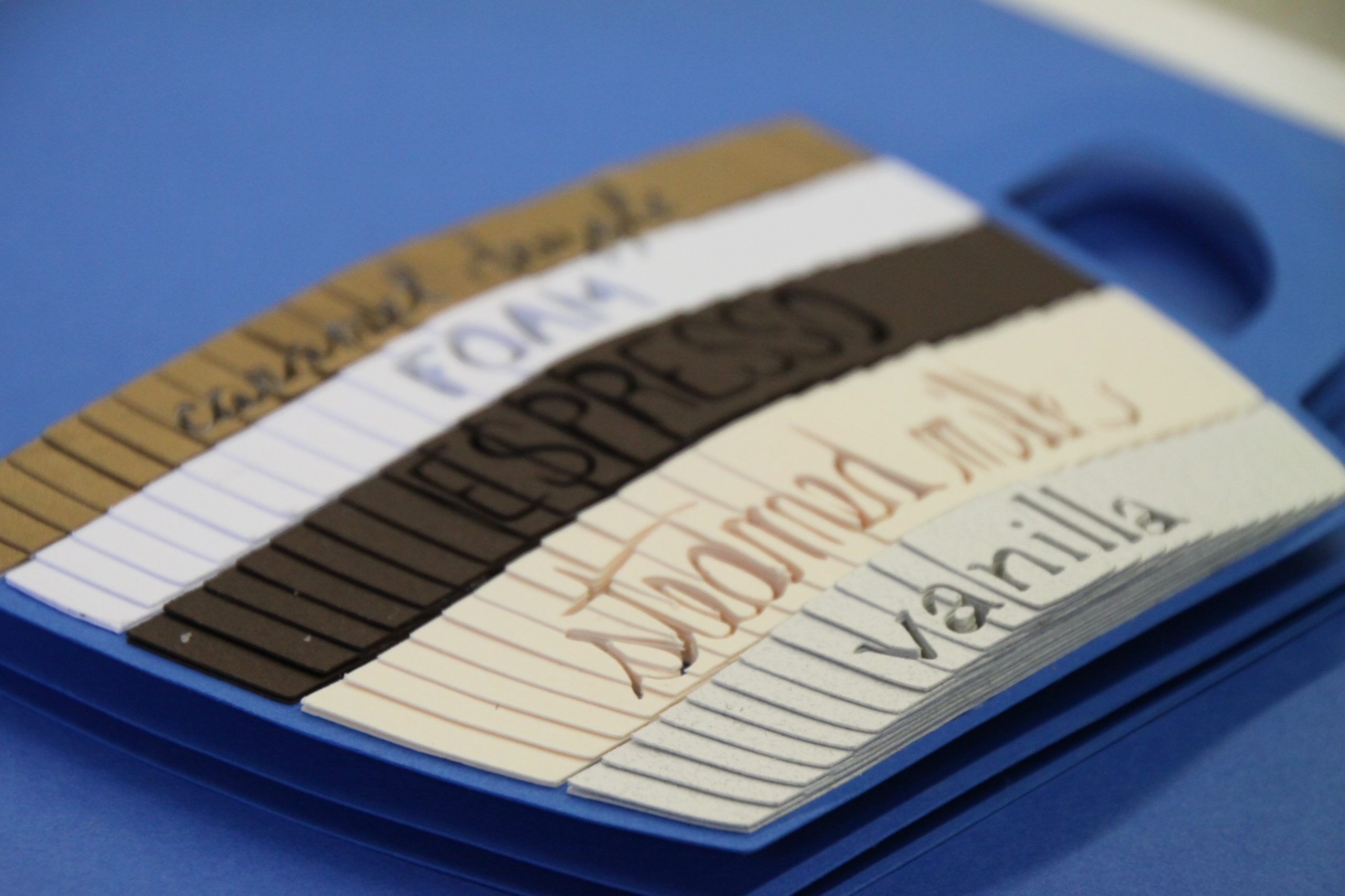 caramel macchiato Stack of lined notebooks including composition books and spiral notebooks on blue surface for school supplies