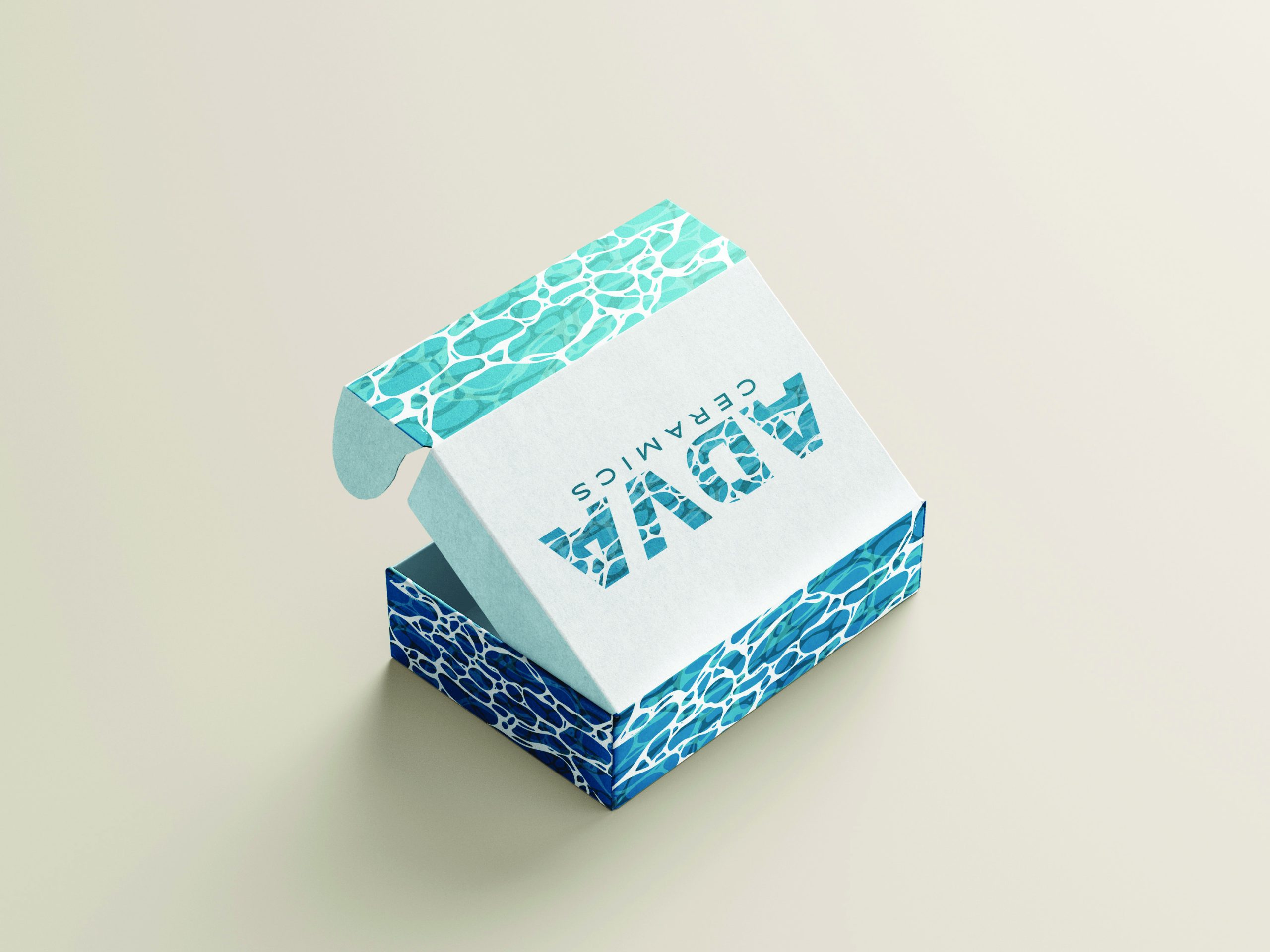 adva-box-top Turquoise and blue water-themed packaging box with organic wave patterns and CERAMICS text on white background