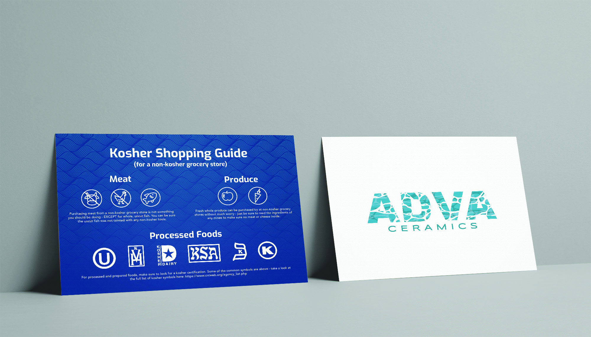 insert-mockup Kosher Shopping Guide card showing kosher symbols next to ADVA Ceramics business card on gray background